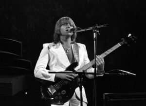 #ELP0065, Greg Lake of Emerson, Lake & Palmer, also known as ELP, are a sporadically active English progressive rock supergroup. They found success in the 1970s and have sold over forty million albums and headlined large stadium concerts. Here headlining California Jam, along with Deep Purple, April 6, 1974, Ontario California.